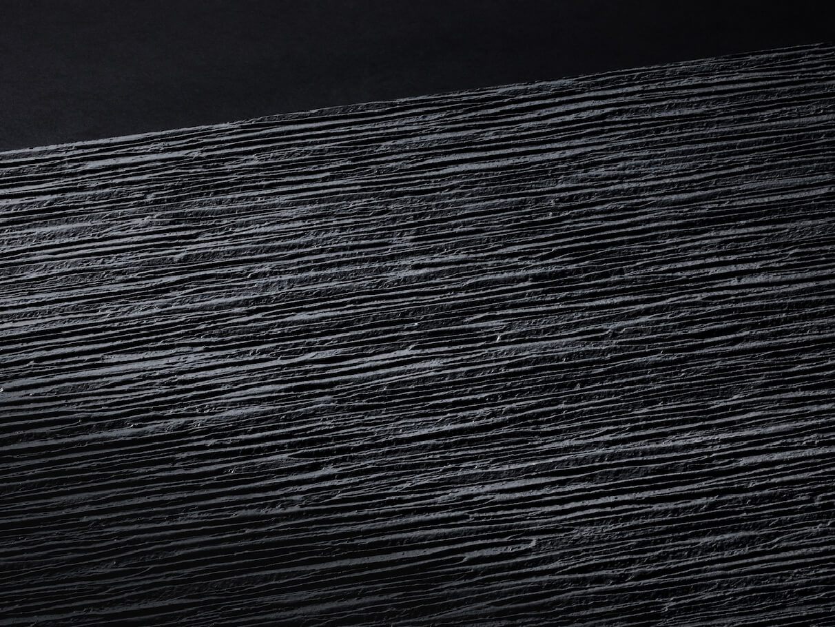 KMEW Facade Panel in black with simple linear pattern, featuring a minimal and refined finish