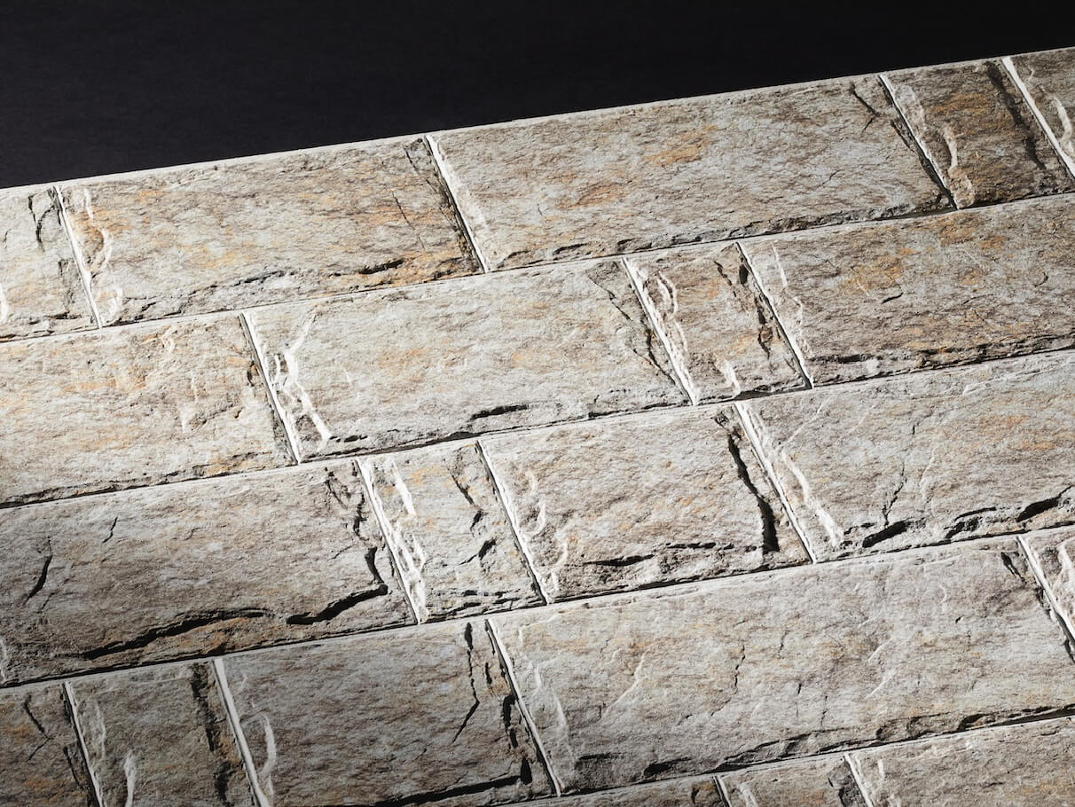 KMEW Facade Panel with rugged rock texture in off-white tone, recreating natural stone details and depth