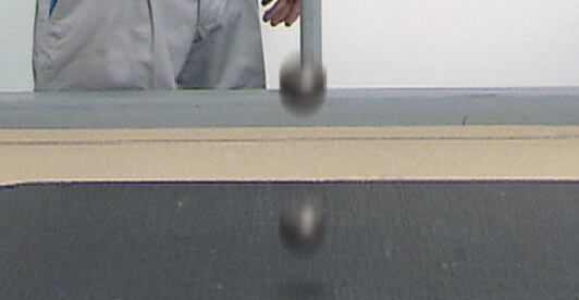 Impact resistance test dropping a steel ball onto a panel to assess surface strength and durability