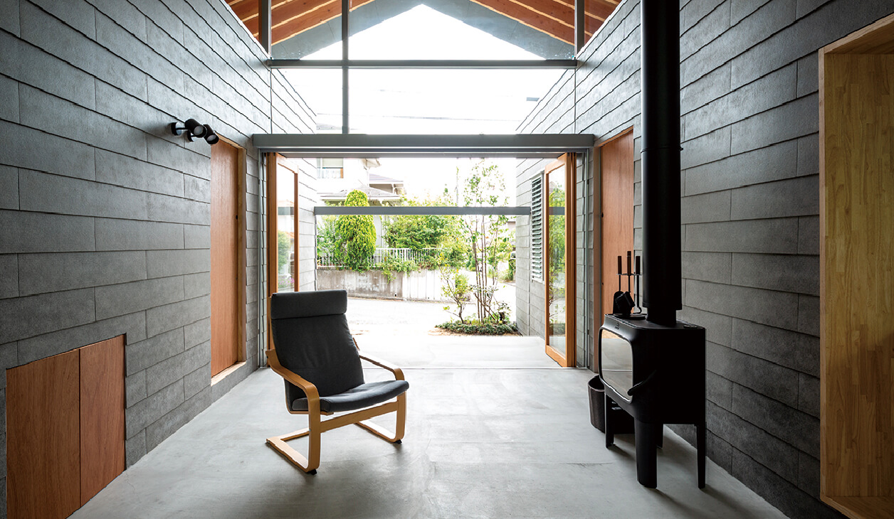 Open architectural space with minimalist furniture and gray KMEW wall material